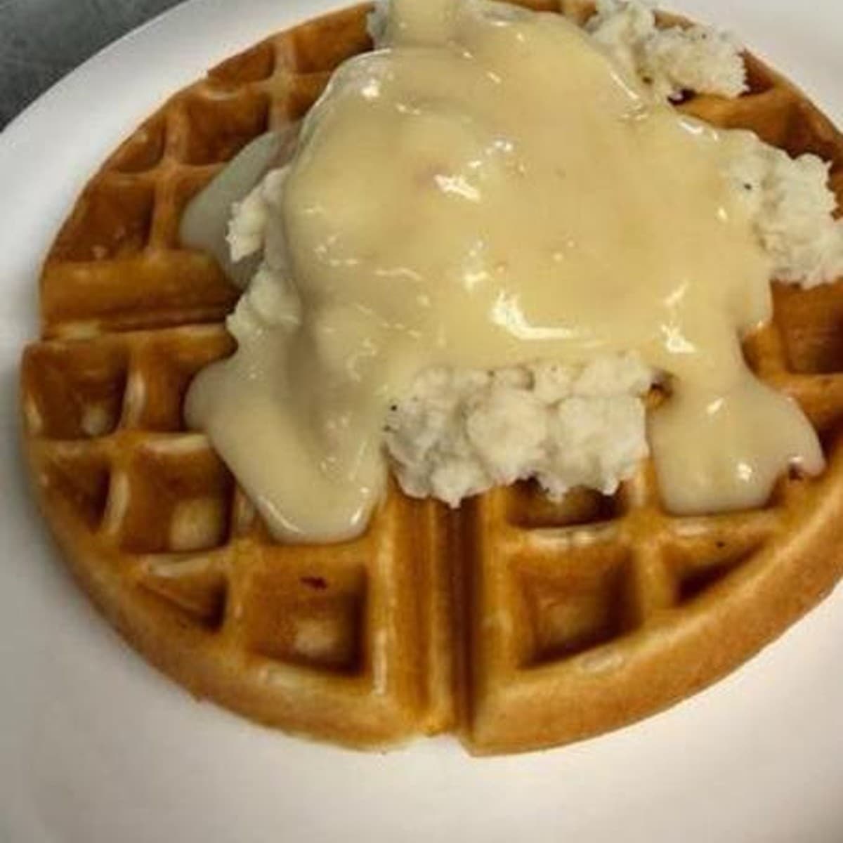 Mom's Famous Waffle — A savory waffle topped with mashed potatoes and gravy