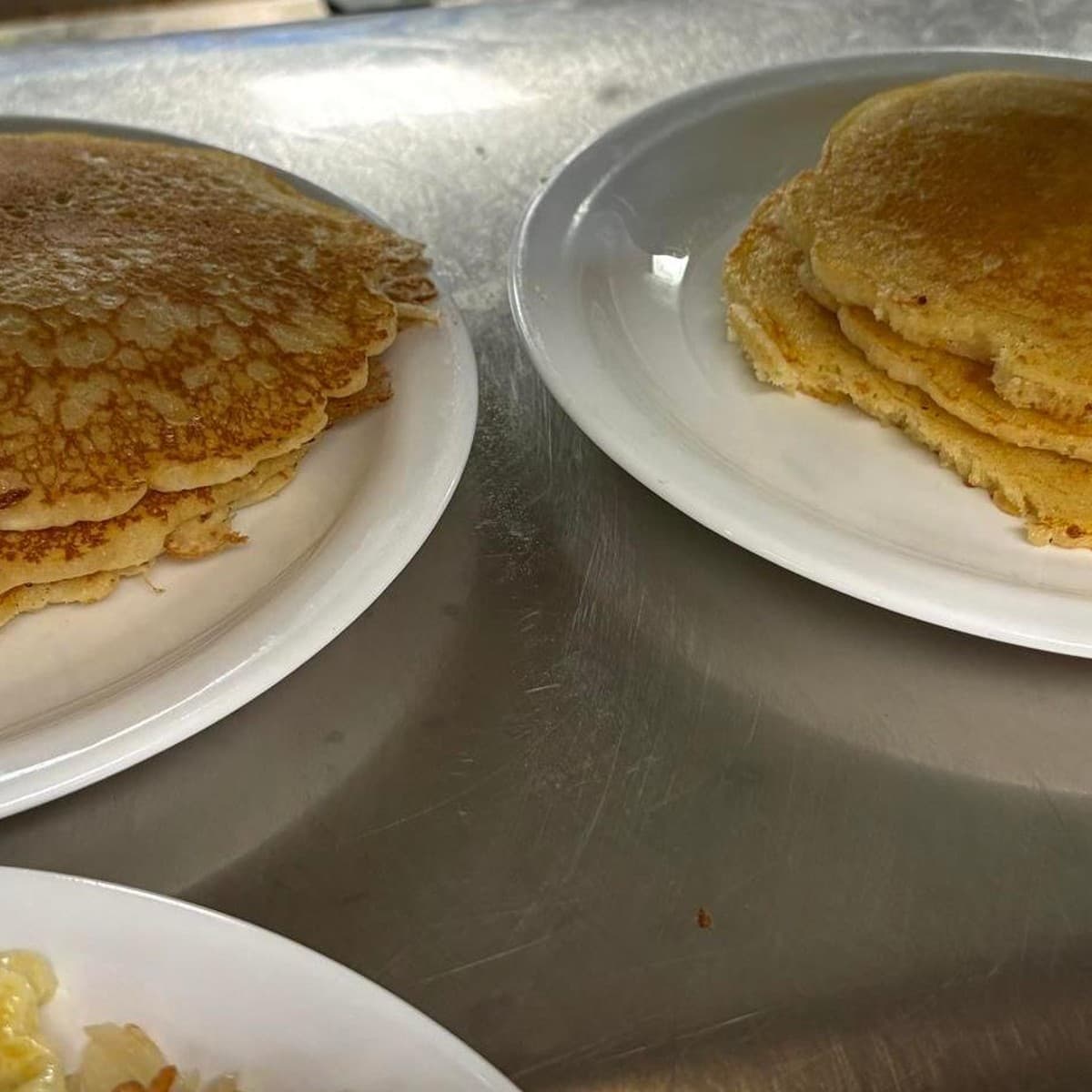Stack of 3 Pancakes — A three-pancake breakfast with butter and syrup